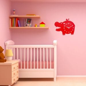 Red accent clock in pink nursery