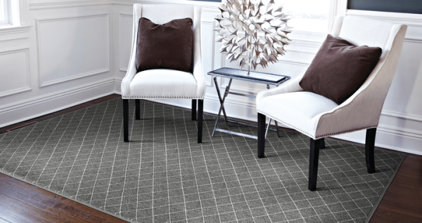 Kenza charcoal rug under white cloth chairs