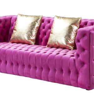 Pink tufted sofa with gold throw pillows